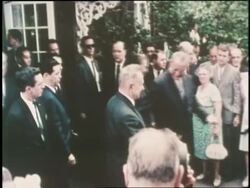 Soviet Foreign Minister Aleksei Nikolaievich Kosygin and President Lyndon B. Johnson leave the White House surrounded by a crowd. News Clip