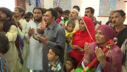 Defiant devotees celebrate saint's birthday at massacre site News Clip