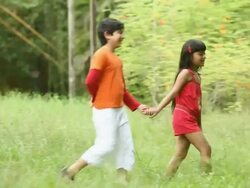 Boy and girl romancing in a park  Stock Footage