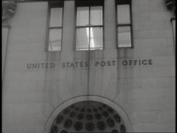 Letters on a stone building read, United States Post Office. News Clip