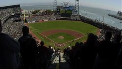 Fans watch a San Fransisco Giants game from behind the home plate at AT and T Park in San Fransisco. Stock Footage
