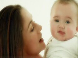 CU mother and baby playing on cushions Stock Footage