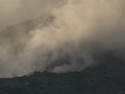 Smoke drifts from an active lava flow on the side of erupting volcano, Philippines, Dec 2009 Stock Footage