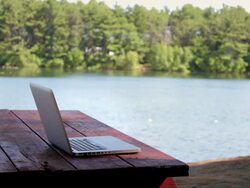 MS Laptop on table near lake / Portland, ME, United States Stock Footage