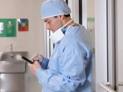MS Man in Surgical Scrubs Using Smartphone in Hospital / Richmond, Virginia, USA Stock Footage