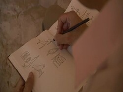 Man drawing Egyptian hieroglyphics in notebook, Sakkara, Egypt (sound available) Stock Footage
