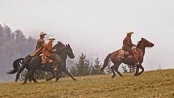SLO MO TS Three cowboys riding horses in gallop Stock Footage