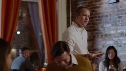 Waiter takes dinner orders and jots them on notepad Stock Footage
