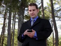 MS Man talking on mobile  and becoming exciting in forest / Portland, ME, United States Stock Footage