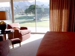 TS mid-century modern bedroom with floor-to-ceiling glass window and slider door overlooking country club golf course Stock Footage