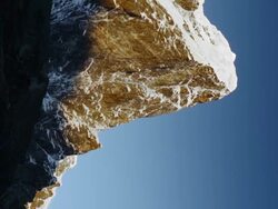 Vertical shot of Time-lapse of the moon passing by Himalayan peaks at sunrise. Stock Footage