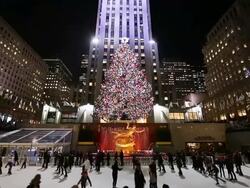 MS Shot of Skaters and illuminated Christmas Tree at Rockefeller Center at night / New York, United States  Stock Footage