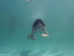 Young woman swimming underwater Stock Footage