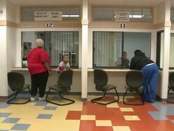 2009 WS People standing at counters in job center application area/ Antioch, California, USA/ AUDIO Stock Footage