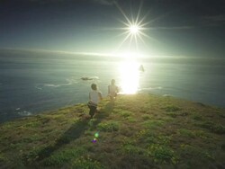 MS ZO SLO MO Couple practicing yoga overlooking Pacific Ocean / Port Orford, Oregon, United States Stock Footage