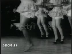 1936: CHORUS GIRLS: * Female legs in short skirts tap dancing on stage, lead female legs are woman of color, Black, African-American. Instructional Video