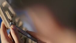 Craftsman shaves edge of wooden frame with chisel Stock Footage