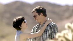 Young couple embrace in desert cactus grove Stock Footage