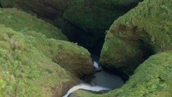 The keyhole of Kaluanui waterfall, viewed from above. Stock Footage