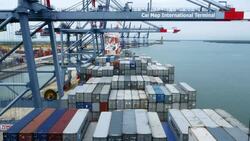 Shipping containers being loaded onto a container ship Stock Footage