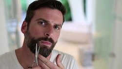 Man trimming beard with scissors Stock Footage
