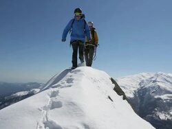 Boom as two climbers descend from mountain summit Stock Footage