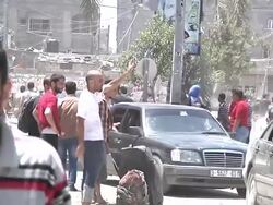 Gazans walk amid rubble collecting belongings News Clip