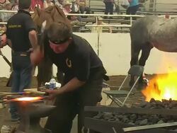 MS Shot of participators playing in blacksmith competition at Calgary Stampede / Calgary, Alberta, Canada Stock Footage