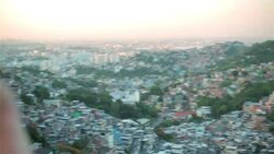 Camera pans over Rio de Janeiro skyline to man taking photo with smartphone Stock Footage