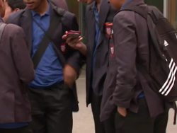 Children in classroom using mobile phones and tablet devices. News Clip