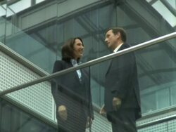 Ws male and female meeting on office walkway with handshake, UK Stock Footage