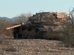 WS ZI Broken down tank in the desert Stock Footage