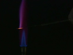 A flame test used in chemistry to detect the presence of certain metal ions, based on each elements characteristic emission spectrum (Potassium Carbonate) Stock Footage