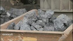 Iron ore and chimneys outside steelworks News Clip