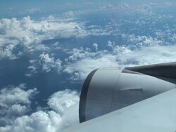Airborne plane flying among white soft clouds Stock Footage