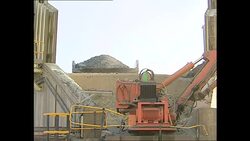 Rock being crushed at a diamond mine News Clip