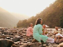 Two senior couple drinking coconut water at riverbank, Ganges River, Rishikesh, Uttarakhand, India Stock Footage