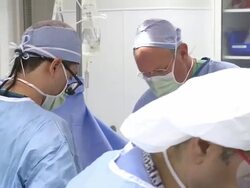 Doctors in operating room performing surgery Stock Footage