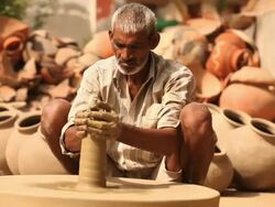 Man making a earthen pot on a pottery wheel, Faridabad, Haryana, India Stock Footage