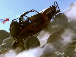 MS  ZO ZI Rock crawler spinning wheels of his modified all terrain jeep trying to climb steep hill / Salton City, California, USA Stock Footage
