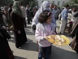 Girl giving food to protesters in Tahrir Square News Clip