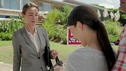 Realtor giving couple keys in front of house with Sold sign Stock Footage