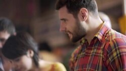 Friends flip through stacks of vintage vinyl in crowded record store Stock Footage