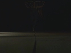 low angle shot woman running towards camera with American flag Stock Footage