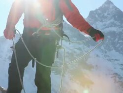 Portrait of climber pulling rope tight to teammates Stock Footage