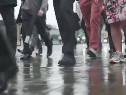 Commuters going to work in the rain Stock Footage