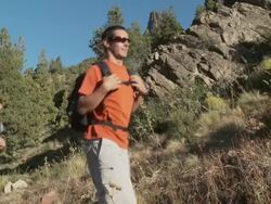 People hiking though rural landscape Stock Footage