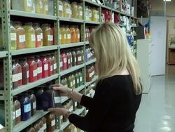 MS View of Woman Examins Jar of Colour Pigment / Dusseldorf, Germany Stock Footage