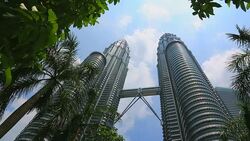 Petronas Towers with Trees and Palm, Kuala Lumpur, Malaysia Stock Footage