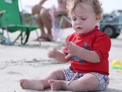 MS TU Shot of baby boy playing with an American flag on beach / St Simon's Island, Georgia, United States Stock Footage